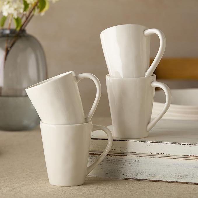 Set of matte cream stoneware mugs with curved silhouette